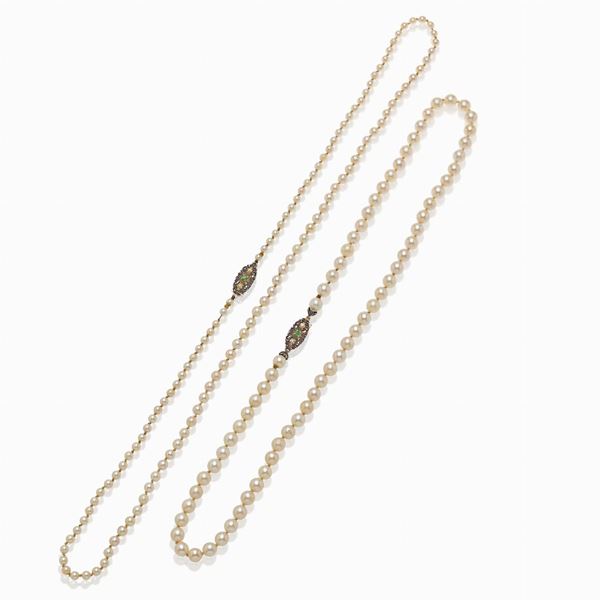 White gold and silver stand necklaces of cultured pearls and emeralds