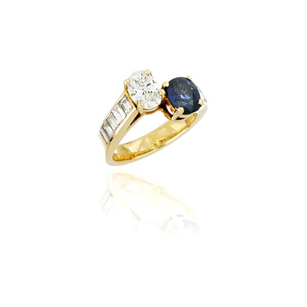 Gold contrariè ring with diamond and sapphire