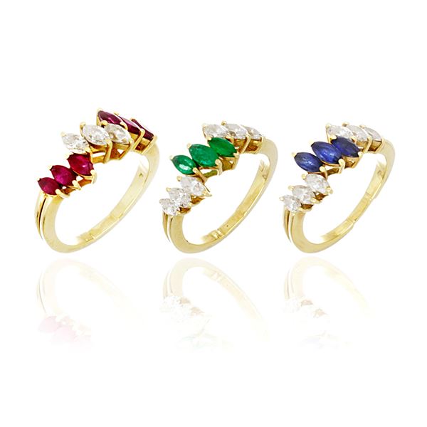 Lot consisting of three gold rings with diamonds, sapphires, rubies and emeralds