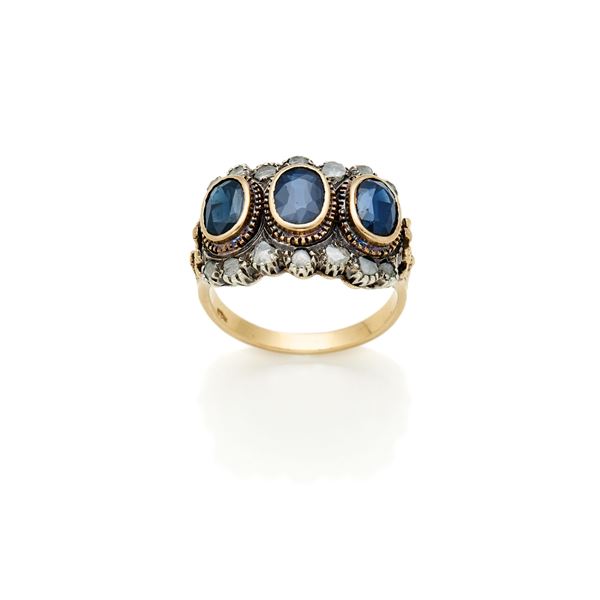 Gold and silver ring with diamonds and sapphires 