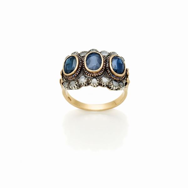 Anello in oro e argento con diamanti e zaffiri 