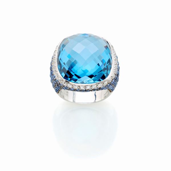 Gold ring with diamonds, sapphires, and synthetic sapphire