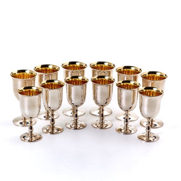 Six silver wine glasses and six silver water glasses