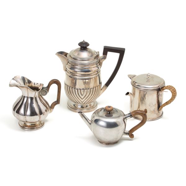 Three silver teapots and a milk jug