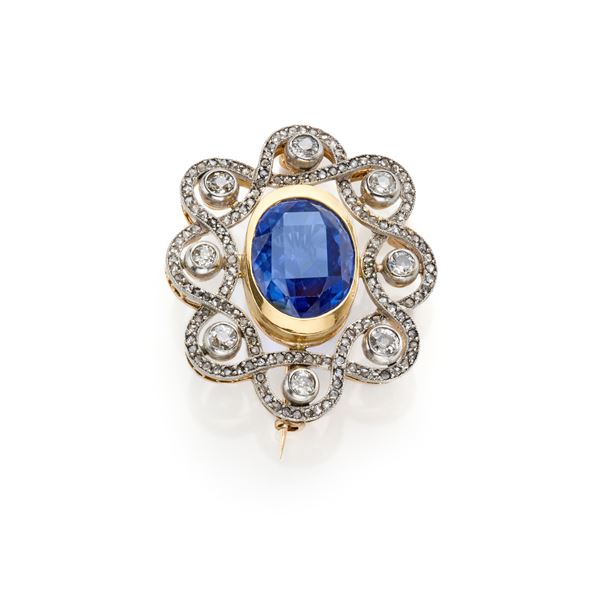 Gold brooch with oval sapphire and diamonds