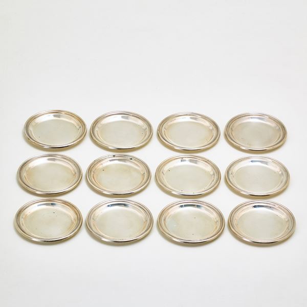 Twelve silver bread plates