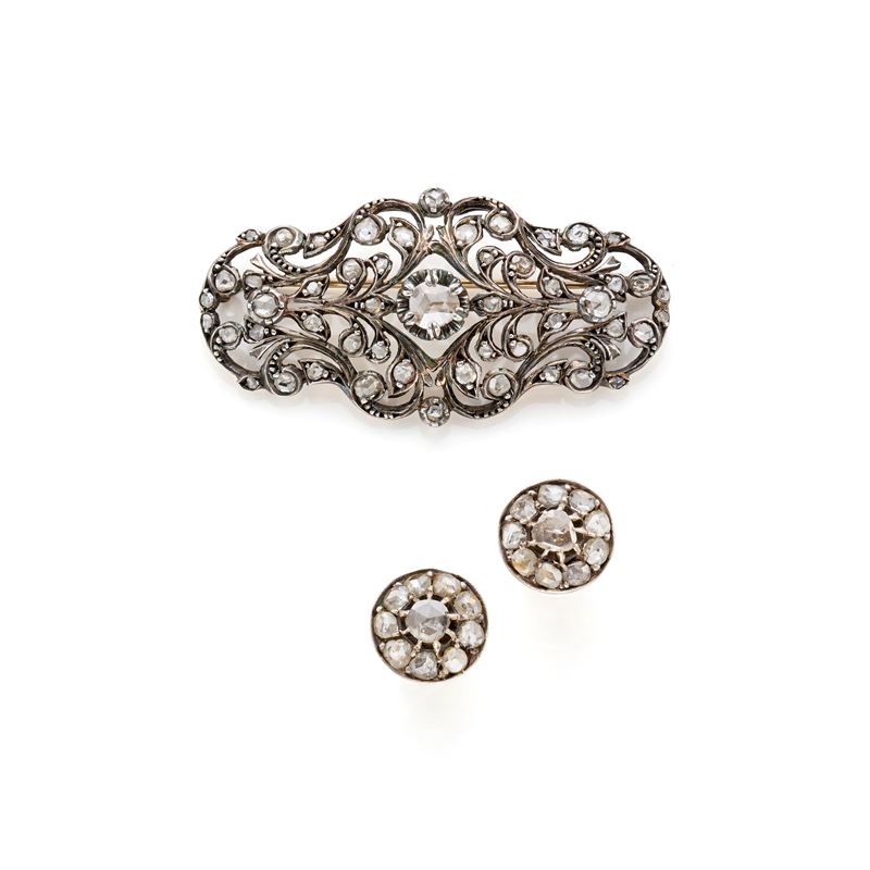 Lotto in oro e argento composto da spilla e orecchini